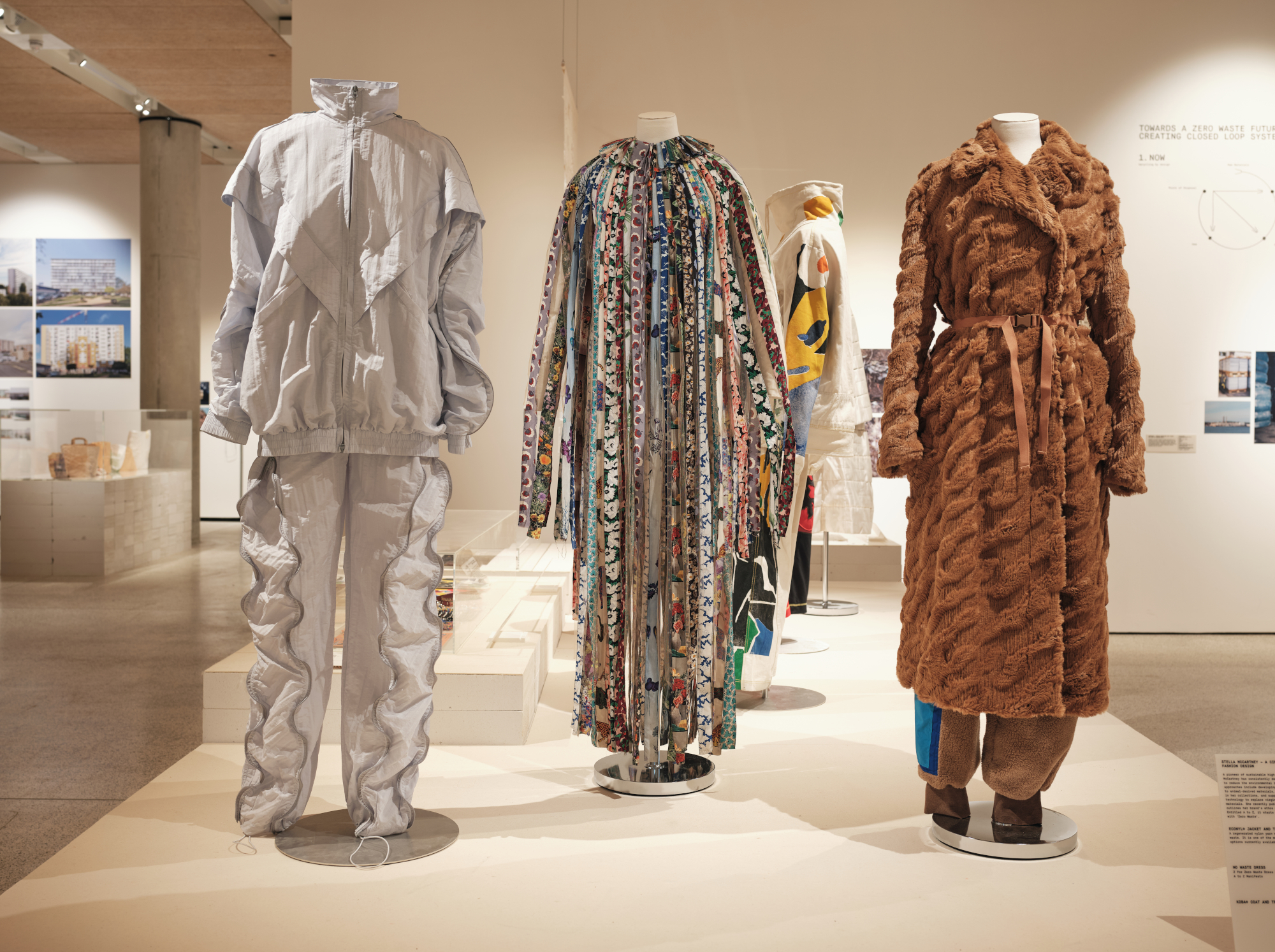 Three garments from Stella McCartney demonstrating a circular approach to
fashion design, including: ECONYL® Jacket and Trousers, Stella McCartney,
Summer 2019 Collection (left); No Waste Dress, Stella McCartney, Spring 2021
Collection (middle); KOBA® Coat and Trousers, Stella McCartney, Autumn
2021 Collection